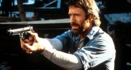 Chuck Norris points a gun in a scene from the film 'Hero And The Terror', 1988. (Photo by Cannon/Getty Images)