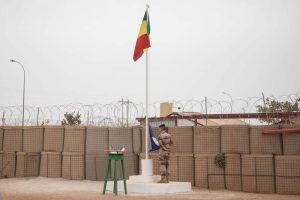 (FILES) In this file photo taken on December 14, 2021 The Malian flag is hoisted during the handover ceremony of the Barkhane military base from the French to the Malian army in Timbuktu. - The last soldiers belonging to France's Barkhane operation in Mali have now left the African country, the French chiefs of staff said on August 15, 2022.
French forces have been supporting Mali against insurgents for nearly a decade, but President Emmanuel Macron decided to pull out after France and the Malian junta fell out in the wake of a military takeover in August 2020. (Photo by FLORENT VERGNES / AFP)